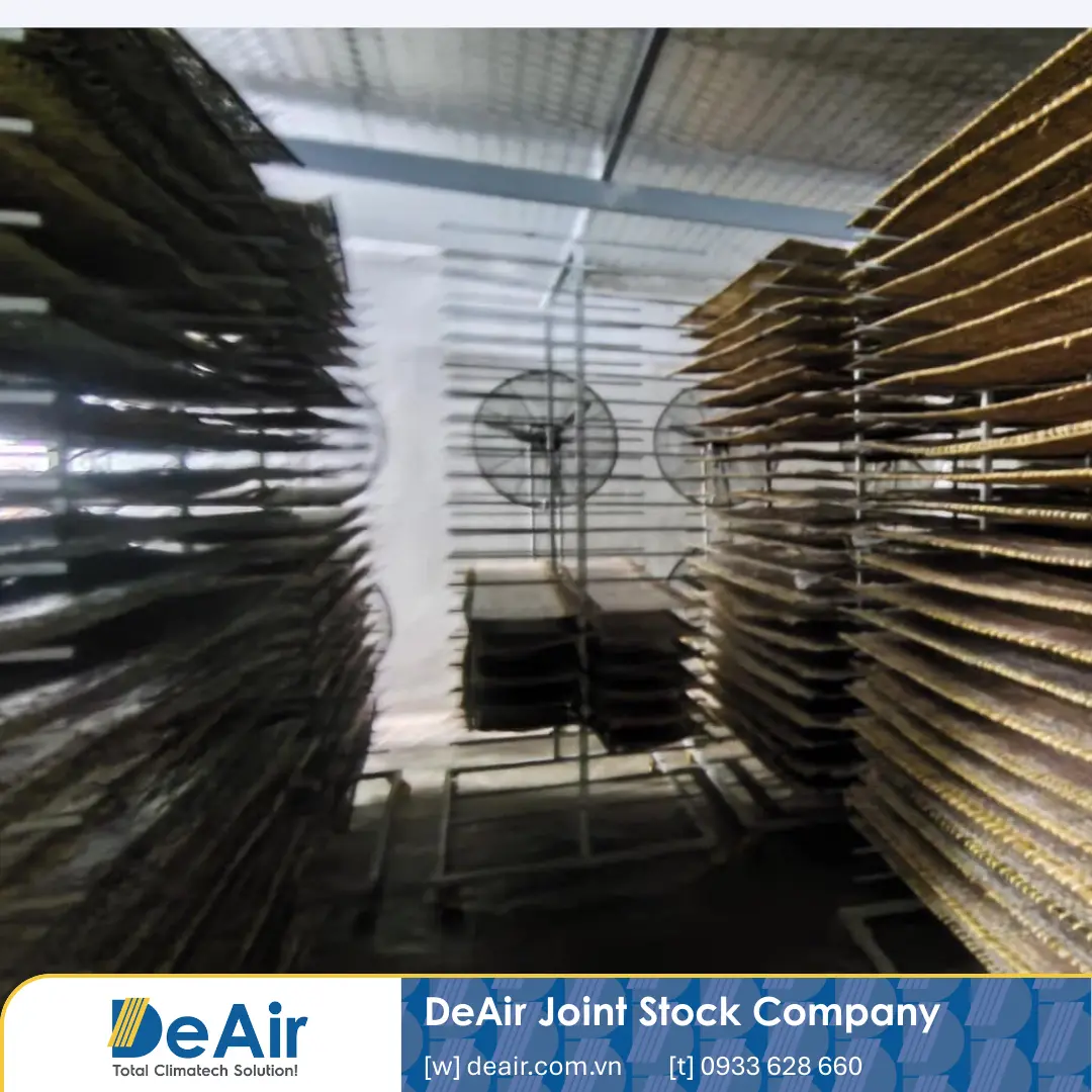 Rice paper trays fully loaded onto stainless steel trolleys and pushed into the closed drying room