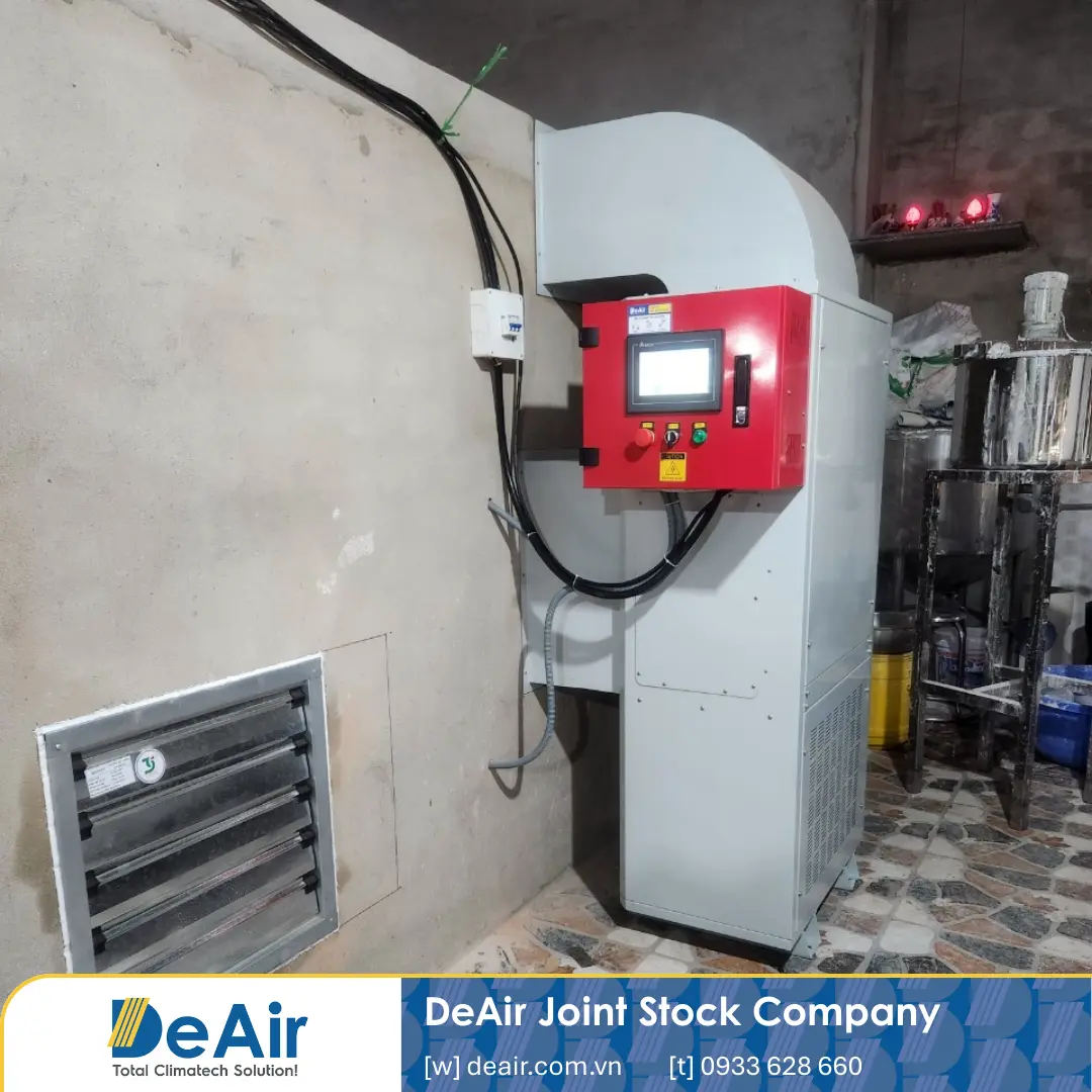 Operator controlling the Daxwell dryer via the HMI/PLC screen outside the drying room