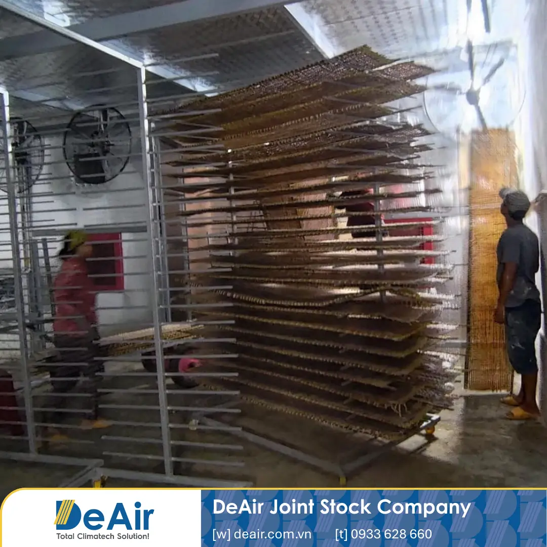 Close-up inside the rice paper drying room with circulating fans and heat-pump dryer